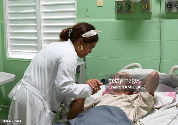 Doctor talks to a patient in the cardiology room of the Calixto Garcia hospital in Havana on February 12, 2024. Alexey Lopez, a 59-year-old...