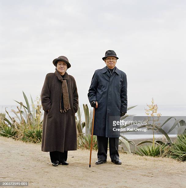 senior couple standing outdoors, portrait - overcoat stock pictures, royalty-free photos & images