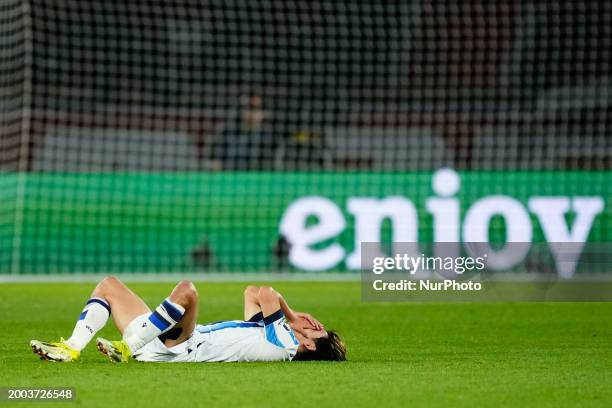 Takefusa Kubo right winger of Real Sociedad and Japan lies injured on the pitch during the UEFA Champions League 2023/24 round of 16 first leg match...