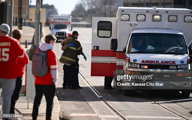 Firefighter waits outside an ambulance near Union Station after several people were shot near a rally there during the Kansas City Chiefs' Super Bowl...