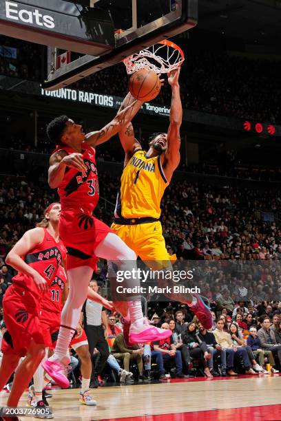 Obi Toppin of the Indiana Pacers dunks the ball during the game against the Toronto Raptors on February 14, 2024 at the Scotiabank Arena in Toronto,...