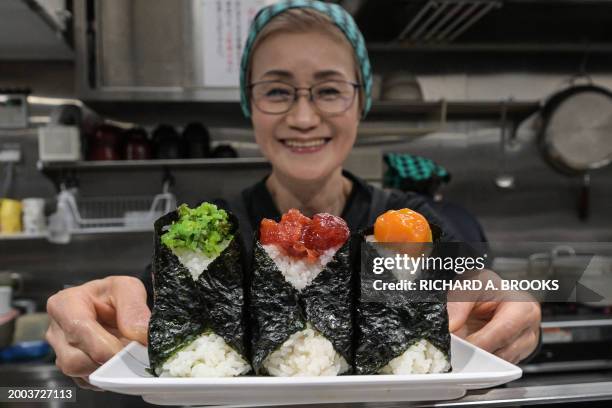 This photo taken on December 7, 2023 shows Yumiko Ukon, who runs the restaurant Onigiri Bongo, a shop specialising in rice balls known as "onigiri",...