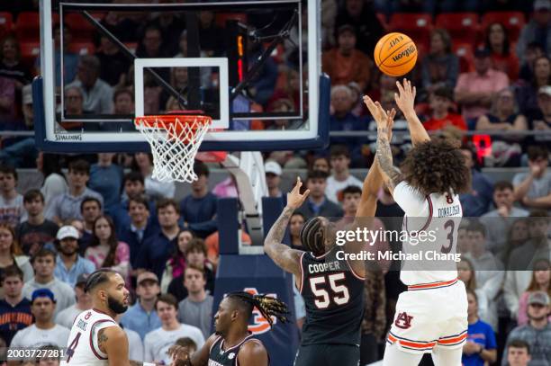 Tre Donaldson of the Auburn Tigers takes a shot over Ta'Lon Cooper of the South Carolina Gamecocks during the first half of play at Neville Arena on...