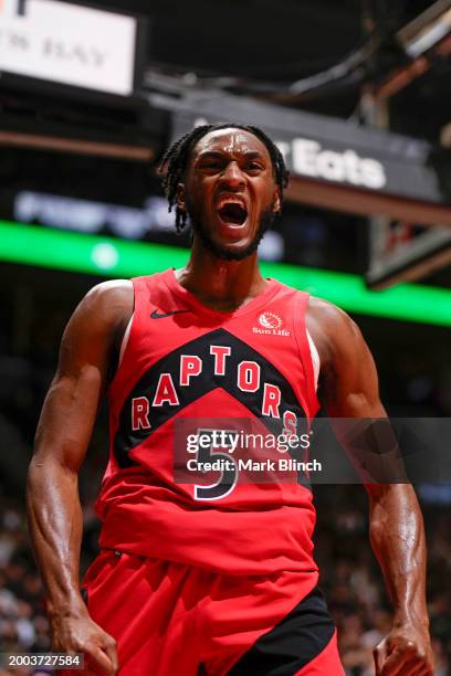 Immanuel Quickley of the Toronto Raptors celebrates during the game against the Indiana Pacers on February 14, 2024 at the Scotiabank Arena in...