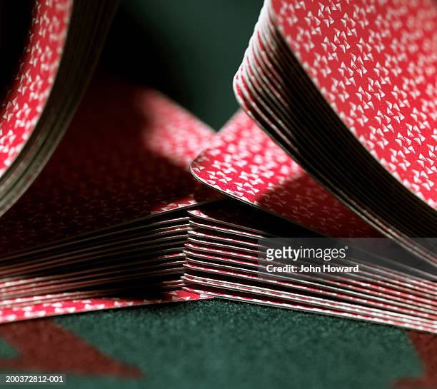 cards being shuffled on gaming table, close-up - barajar fotografías e imágenes de stock