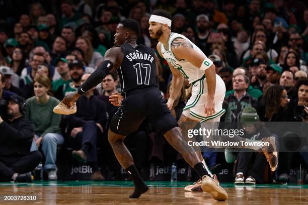 Dennis Schroder of the Brooklyn Nets tries to guard Jayson Tatum of the Boston Celtics holding onto one of his shoes during the second half at TD...