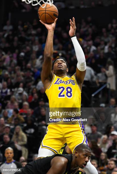 Rui Hachimura of the Los Angeles Lakers shoots over Kris Dunn of the Utah Jazz during the first half of a game at Delta Center on February 14, 2024...