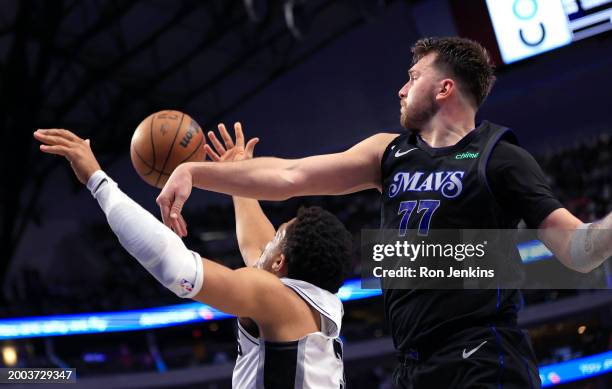 Luka Doncic of the Dallas Mavericks blocks the shot of Keldon Johnson of the San Antonio Spurs in the second half at American Airlines Center on...