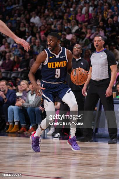 Justin Holiday of the Denver Nuggets dribbles the ball during the game against the Sacramento Kings on February 14, 2024 at the Ball Arena in Denver,...