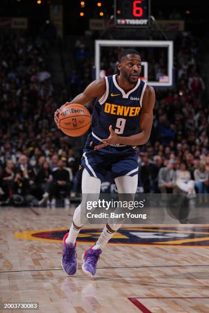 Justin Holiday of the Denver Nuggets handles the ball during the game against the Sacramento Kings on February 14, 2024 at the Ball Arena in Denver,...