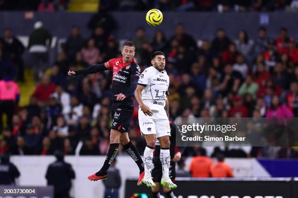 Hugo Nervo of Atlas jumps for a header against Eduardo Salvio of Pumas during the 9th round match between Atlas and Pumas UNAM as part of the Torneo...