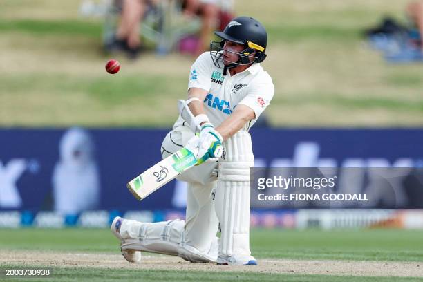New Zealand's Tom Latham plays a shot during day three of the second cricket test match between New Zealand and South Africa at Seddon Park in...