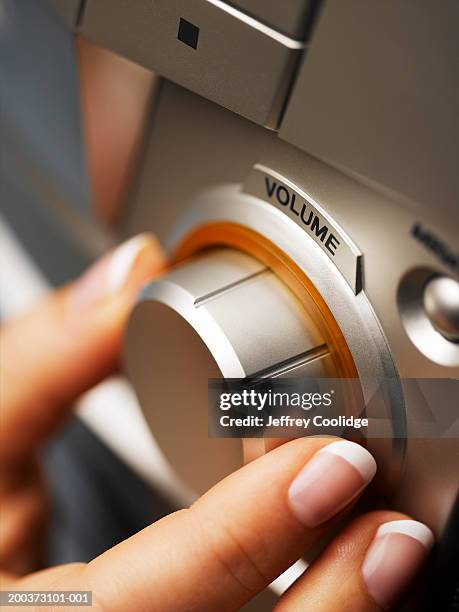 woman adjusting volume on hi fi, close-up - equipo de alta fidelidad fotografías e imágenes de stock