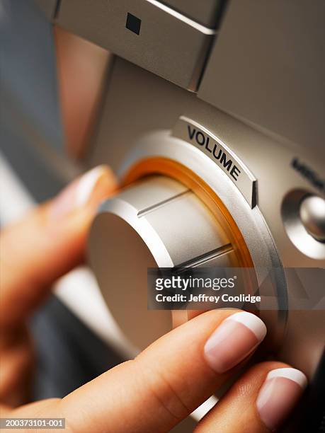woman adjusting volume on hi fi, close-up - turn stock pictures, royalty-free photos & images