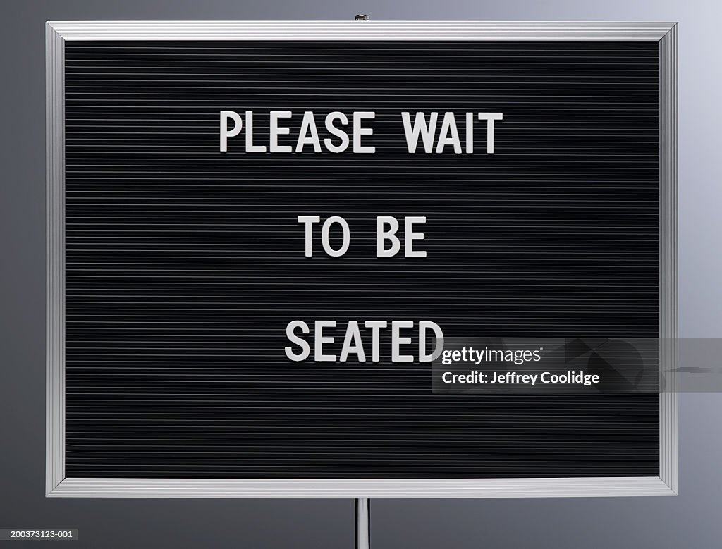 'Please wait to be seated' sign, close-up