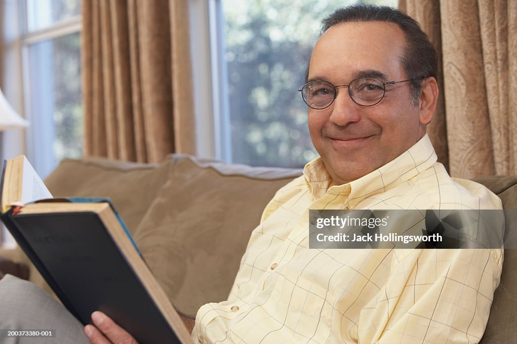 Portrait of a mature man holding a book