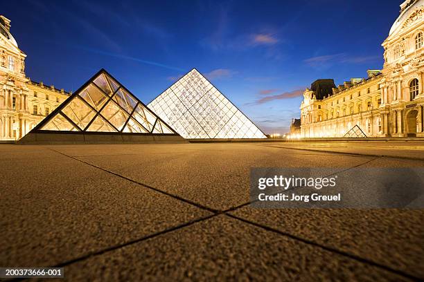 france, paris, louvre museum, exterior illuminated at dusk - louvre pyramid stock pictures, royalty-free photos & images