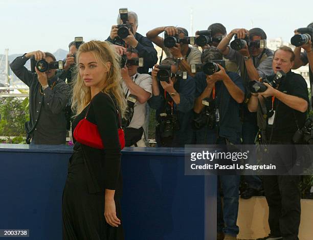 Actress Emmanuelle Beart poses for the cameras during a photocall for the film "Les Egares" at the Palais des Festivals during the 56th International...
