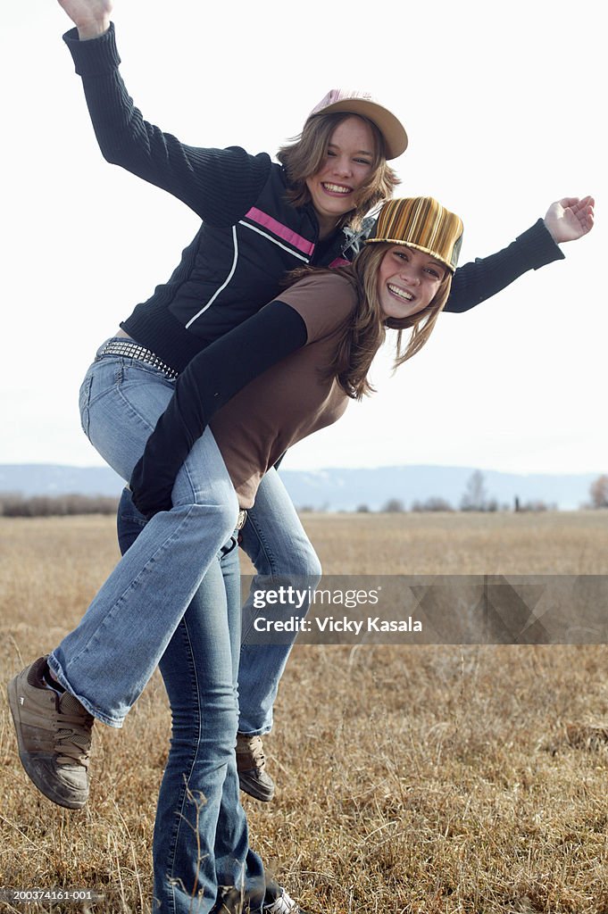 Man Giving Young Woman Piggyback Ride Smiling Side View High-Res Stock  Photo - Getty Images