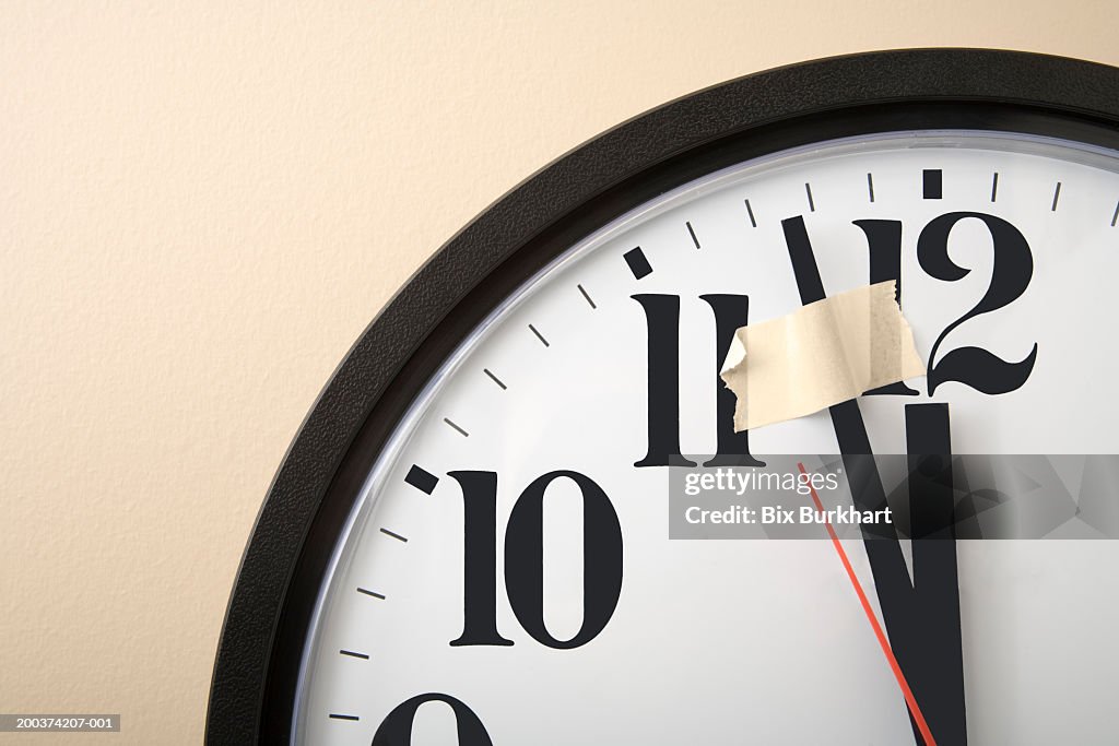 Taped down minute hand on clock