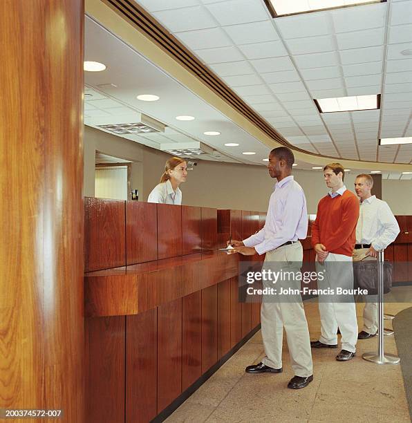 teller helping customer in bank - inside of bank stock pictures, royalty-free photos & images