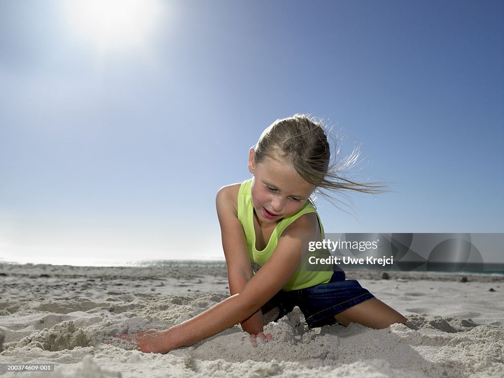 Girl Playing In Sand On Beach High Res Stock Photo Getty Images girl-playing-in-sand-on-beach-high-res-stock-photo-getty-images