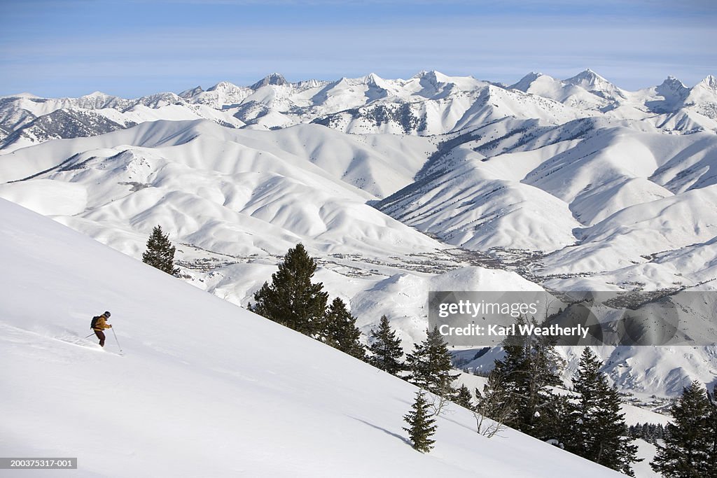 USA, Idaho, Sun Valley, man downhill skiing, side view