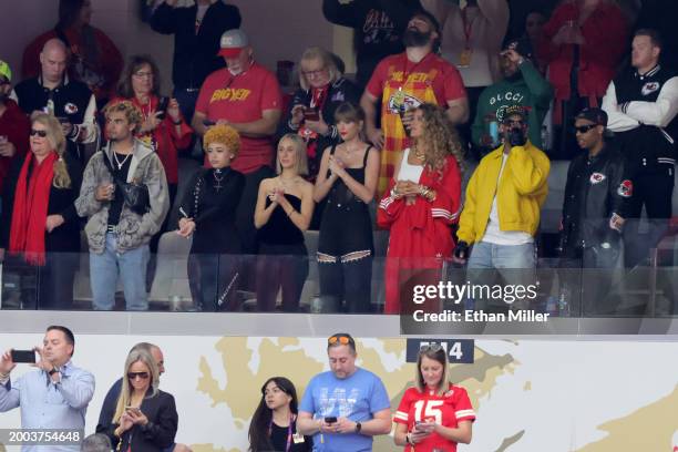 Andrea Swift, RIOTUSA, Ice Spice, Ashley Avignone, Taylor Swift, Blake Lively and Aric Jones, stand in front of Donna Kelce and Jason Kelce before...