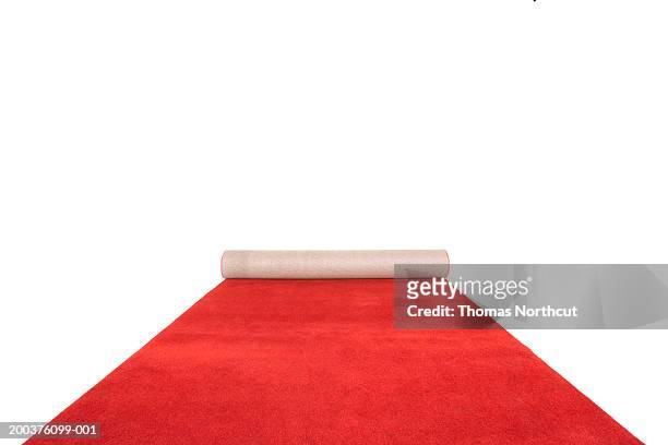 partially unrolled red carpet - red carpet foto e immagini stock