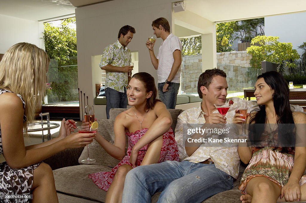 Socializable Group Of People Socializing Indoors Holding Drinks High-Res Stock Photo ...