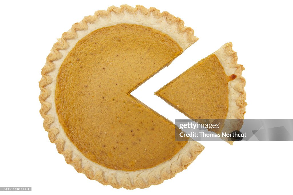 Pumpkin pie with one slice cut out, overhead view