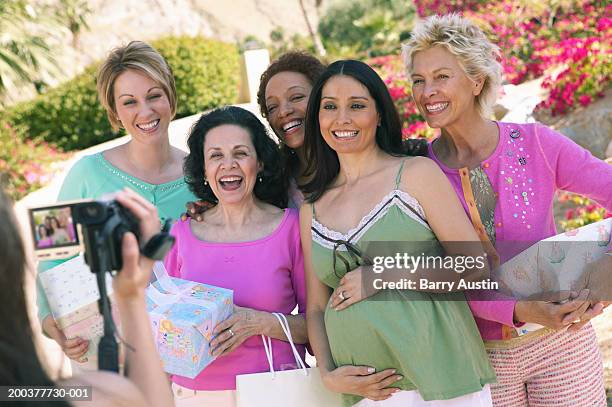 group of women posing for video camera, pregnant woman holding bump - only women videos stock pictures, royalty-free photos & images