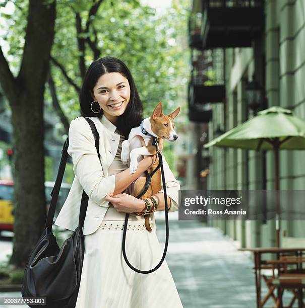 Young Woman Holding Basenji Dog High-Res Stock Photo