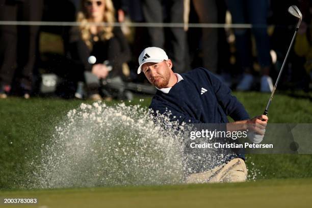 Daniel Berger of the United States plays a shot from a bunker on the 18th hole during the final round of the WM Phoenix Open at TPC Scottsdale on...