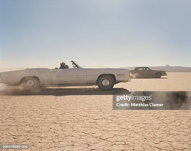 two cars racing in desert, side view - sedan stock pictures, royalty-free photos & images