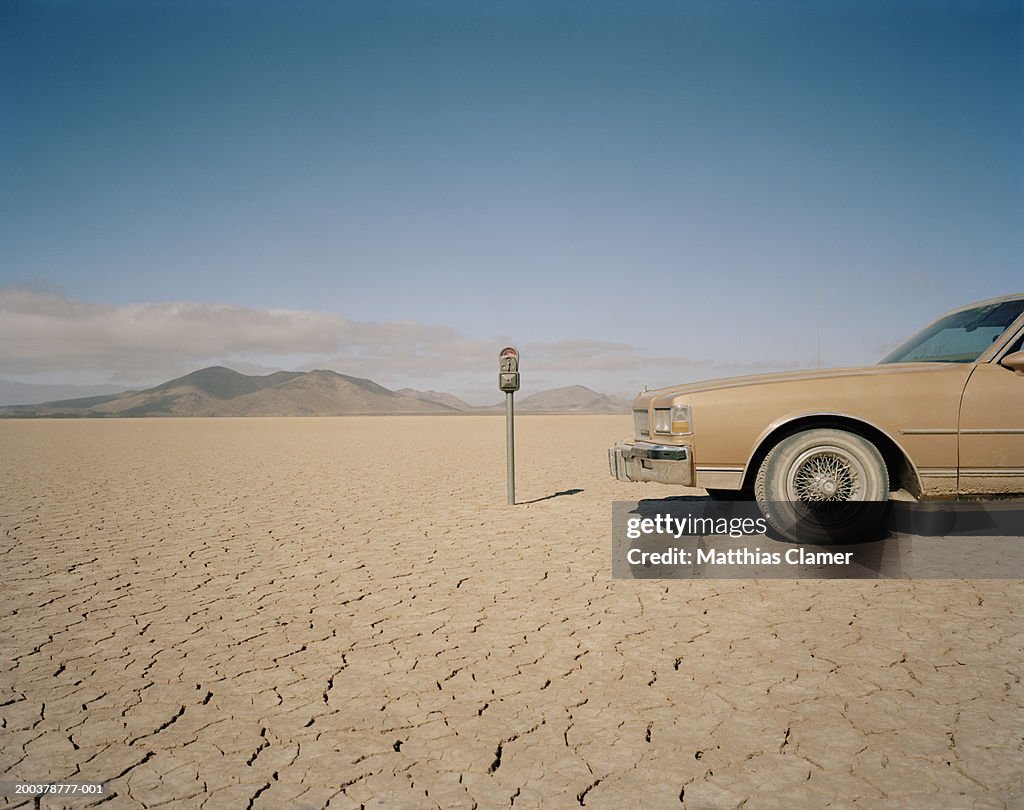 Car parked near expired meter in desert, close-up