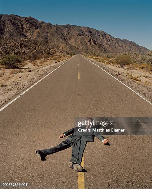 flattened businessman on road, smiling, portrait (digital composite) - roadkill 個照片及圖片檔