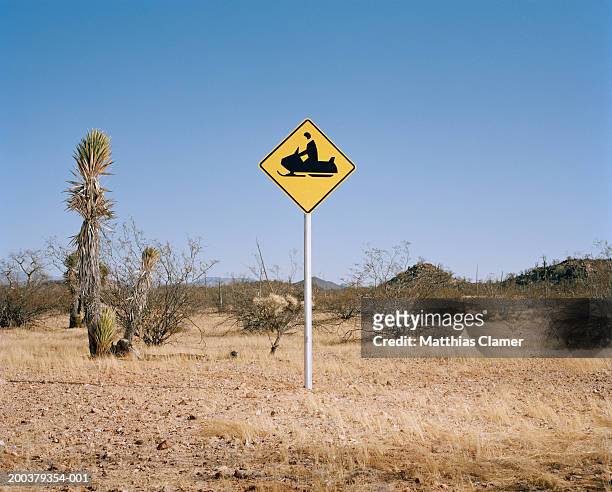 snowmobile warning sign in desert - ironia imagens e fotografias de stock