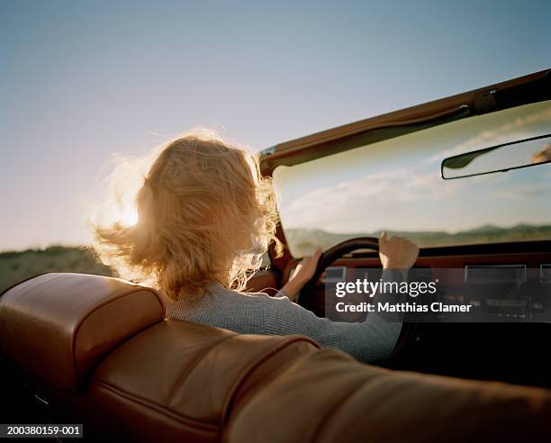 young woman driving convertible, rear view - car rear view mirror stock pictures, royalty-free photos & images