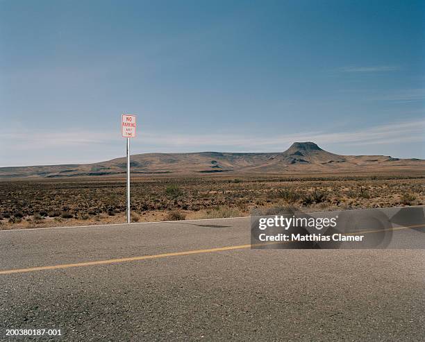 'no parking' sign on desert road - main road stock pictures, royalty-free photos & images