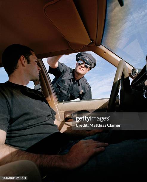 man in car looking at police officer, close-up - traffic cop stock pictures, royalty-free photos & images