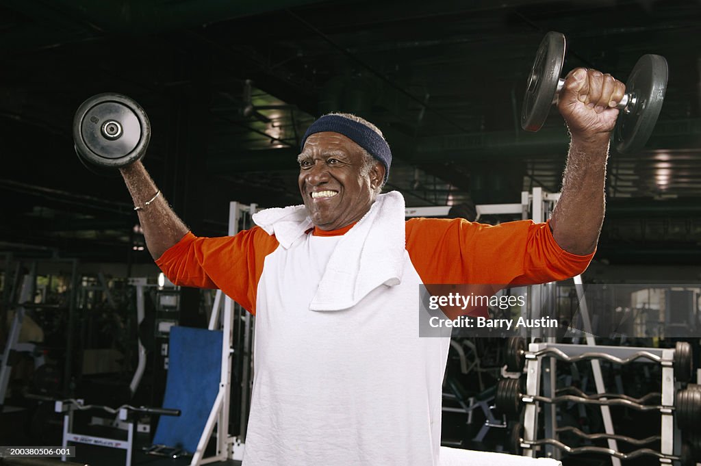 Senior man weight training in gym