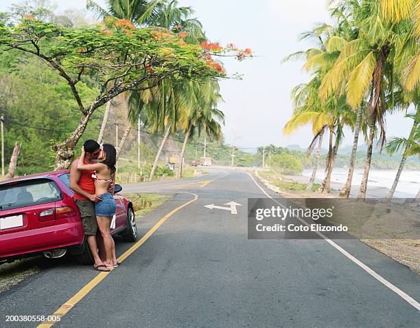 couple kissing on road near beach, side view - playa carrillo stock pictures, royalty-free photos & images