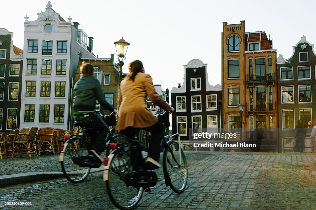 Couple riding bicycles, rear veiw (blurred motion)