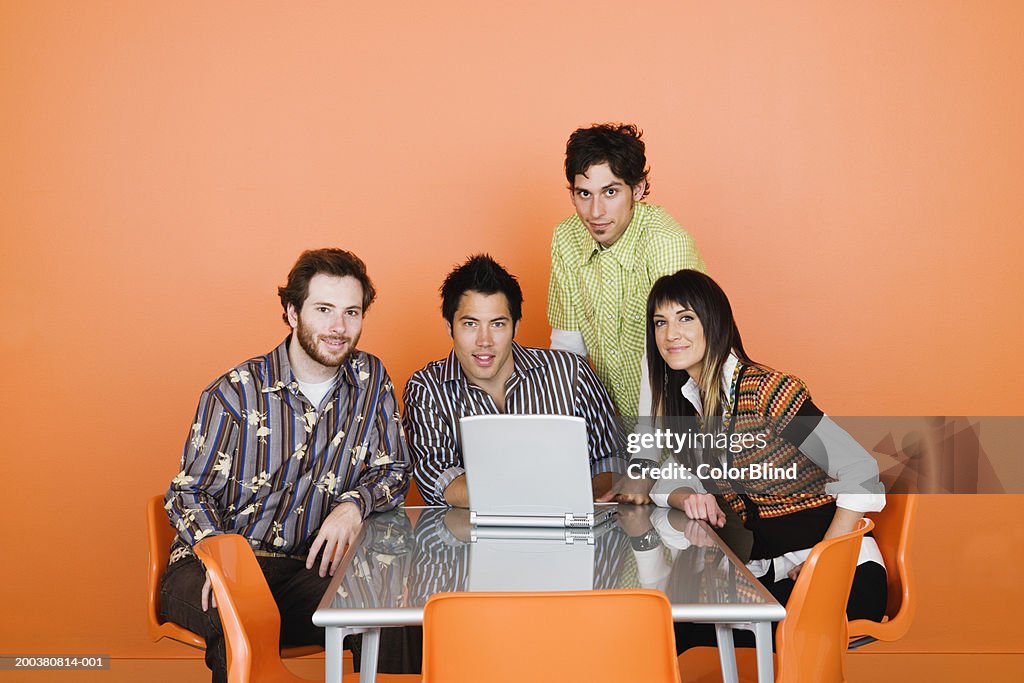 Group of co-workers at table in conference room, portrait