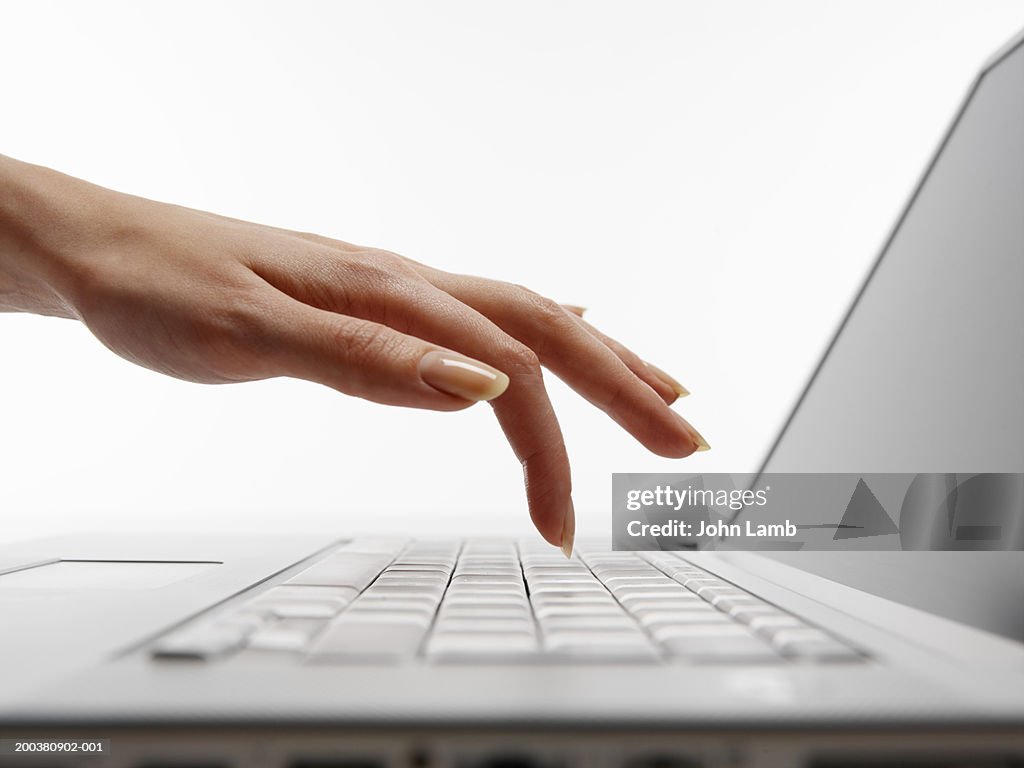 Woman using laptop computer, close-up