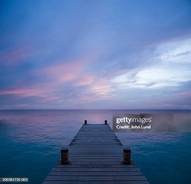 pier at dusk - bonaire stock-fotos und bilder