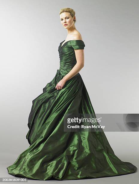 young woman wearing gown, portrait, side view - vestito da sera femminile foto e immagini stock