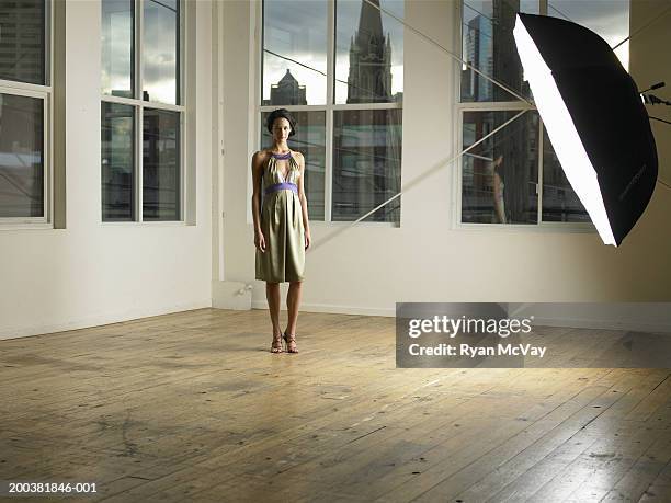 young female model on set, lighting equipment in foreground, portrait - photo shoot model stock pictures, royalty-free photos & images