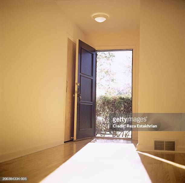 open doorway with light flooding in - open door imagens e fotografias de stock